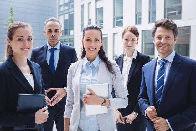 confident-businesspeople-standing-outside-office-building_107420-74308