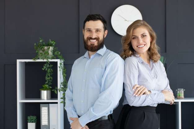 successful-business-partners-with-young-man-woman-posing-back-back_137441-2531